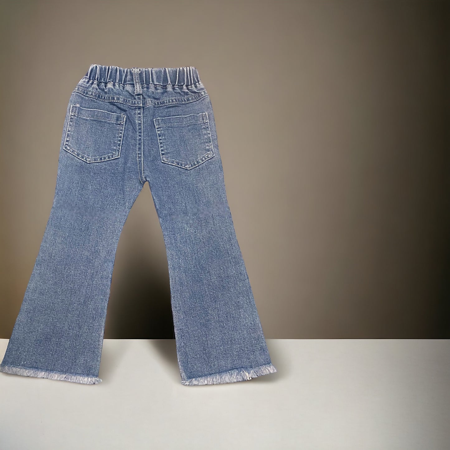 Flared distressed fringe bottom jeans