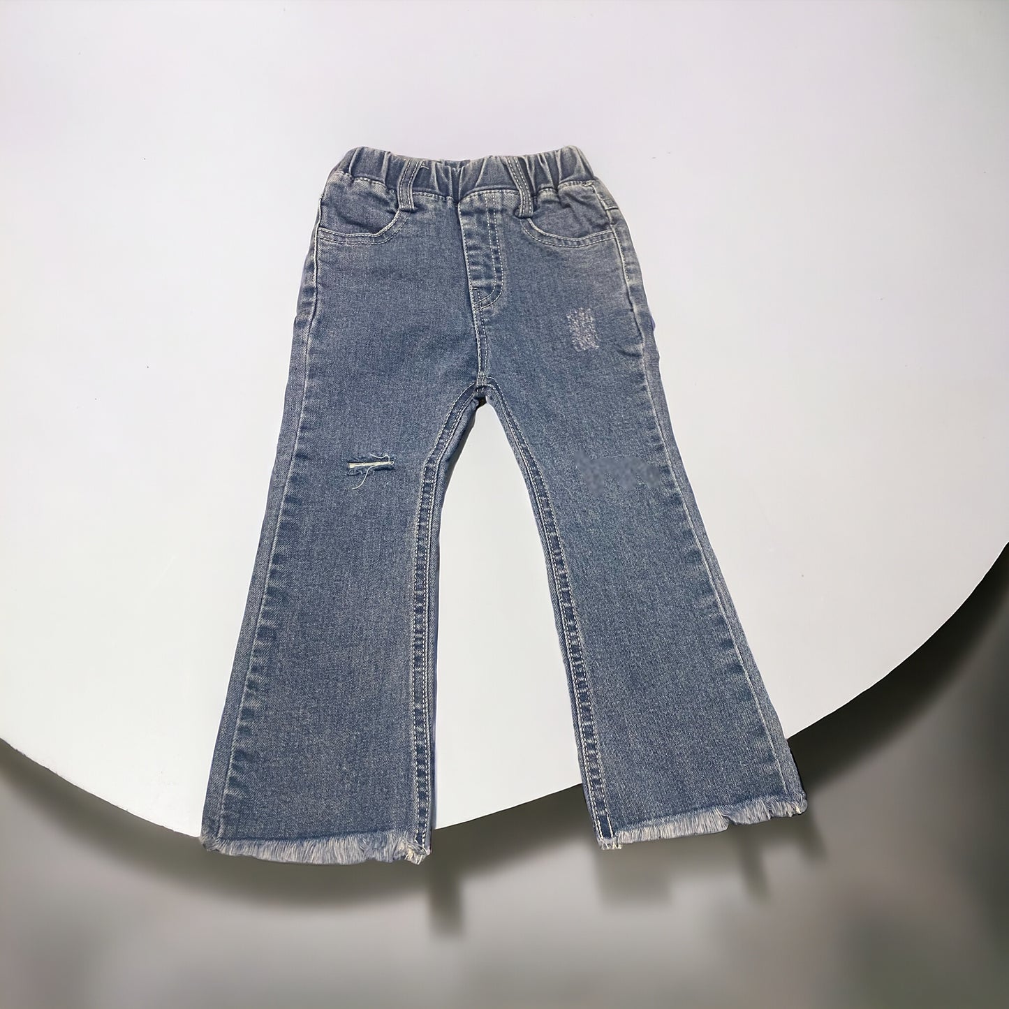 Flared distressed fringe bottom jeans